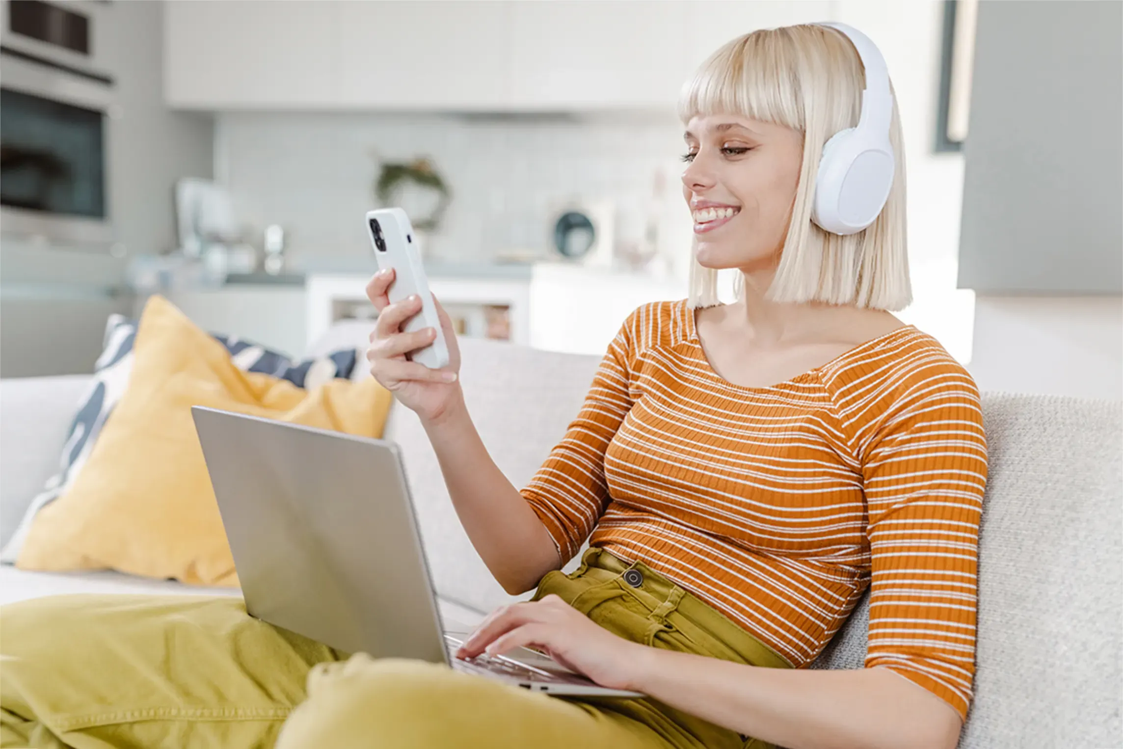 Woman uses cell phone and laptop with new router.